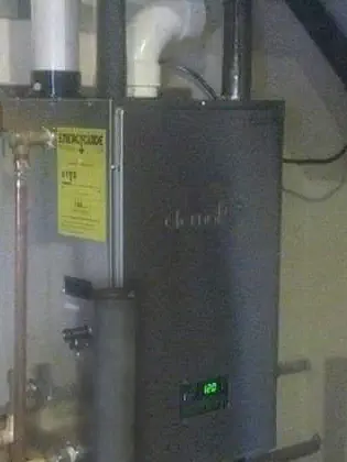 A new tankless water heater on a wall with new gas and water piping